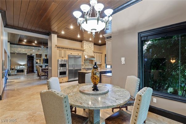 Chandelier, Dining room, Interior, Kitchen, Pendant Lights, Recessed Lighting, Stainless Steel Appliances, Stone Walls, Wooden Ceilings