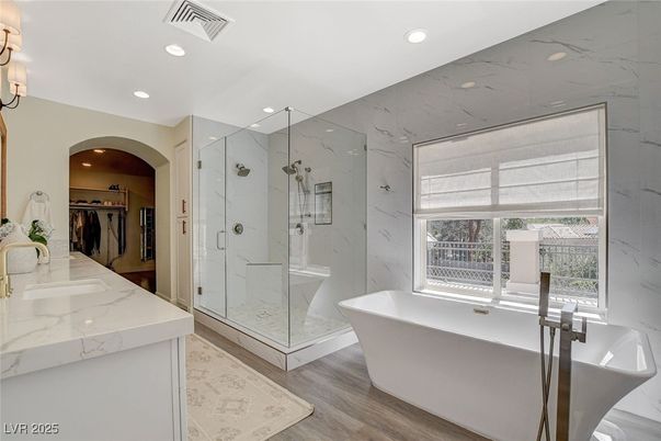 Bathroom, Free Standing Baths, Glass Shower, Interior, Marble Walls, Recessed Lighting, Wood Texture Flooring
