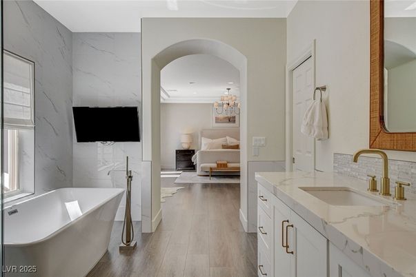 Bathroom, Chandelier, Dual Sink Vanities, Free Standing Baths, Interior, Marble Walls, Recessed Lighting, Wood Texture Flooring