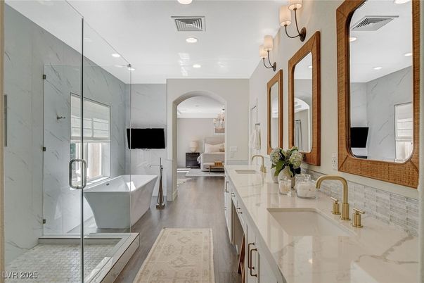 Bathroom, Bedroom, Dual Sink Vanities, Free Standing Baths, Glass Shower, Interior, Marble Walls, Recessed Lighting, Wood Texture Flooring