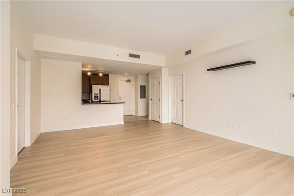 Empty room, Interior, Kitchen, Recessed Lighting, Stainless Steel Appliances, Wood Texture Flooring