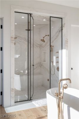 Bathroom, Free Standing Baths, Glass Shower, Interior, Marble Walls, Recessed Lighting, Wood Texture Flooring