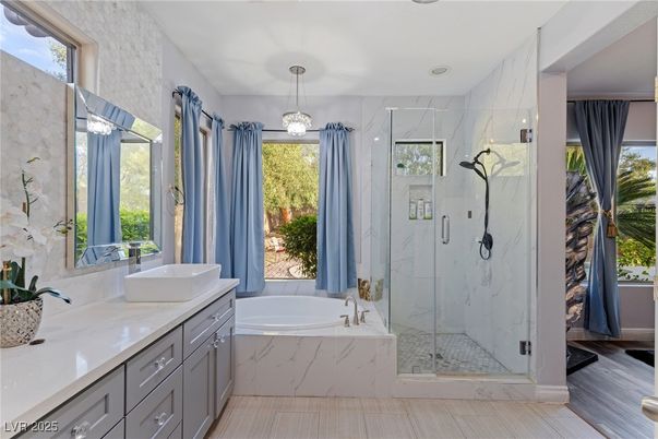 Bathroom, Dual Sink Vanities, Glass Shower, Interior, Marble Walls, Pendant Lights, Recessed Lighting, Wood Texture Flooring