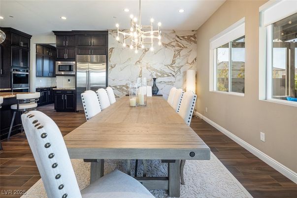 Chandelier, Dining room, Interior, Kitchen, Marble Walls, Pendant Lights, Recessed Lighting, Stainless Steel Appliances, Wood Texture Flooring