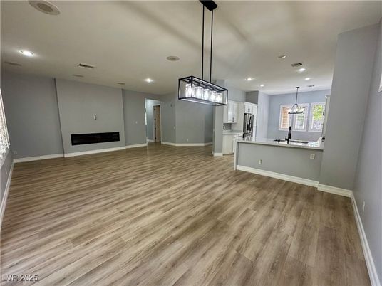 Empty room, Fireplace, Interior, Kitchen, Pendant Lights, Recessed Lighting, Wood Texture Flooring