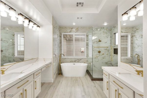 Bathroom, Dual Sink Vanities, Free Standing Baths, Glass Shower, Interior, Marble Walls, Recessed Lighting, Wood Texture Flooring