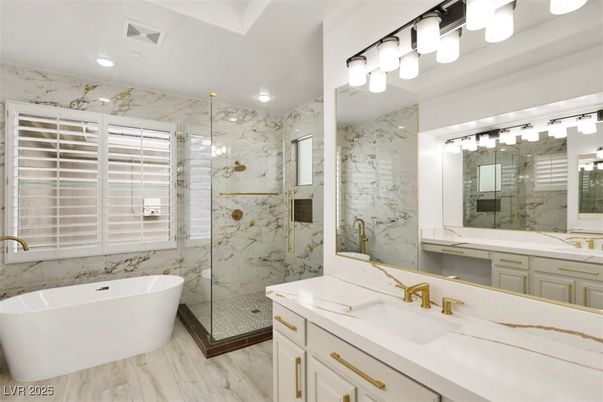 Bathroom, Dual Sink Vanities, Free Standing Baths, Glass Shower, Interior, Marble Walls, Recessed Lighting, Wood Texture Flooring
