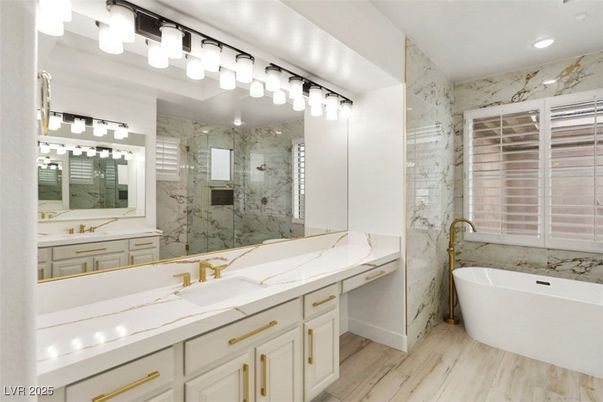 Bathroom, Dual Sink Vanities, Free Standing Baths, Glass Shower, Interior, Marble Walls, Recessed Lighting, Wood Texture Flooring