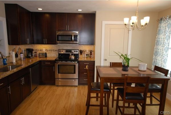 Chandelier, Dining room, Interior, Kitchen, Pendant Lights, Recessed Lighting, Stainless Steel Appliances, Wood Texture Flooring