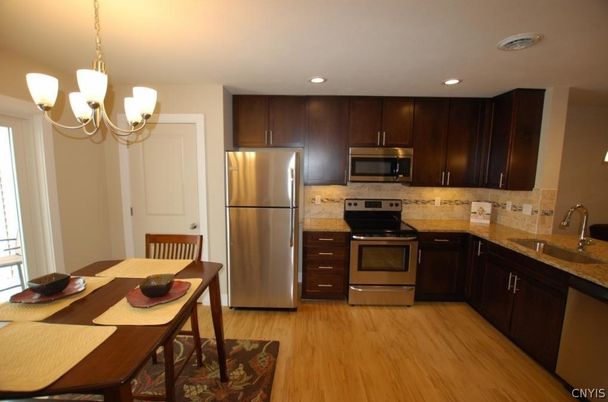 Chandelier, Dining room, Interior, Kitchen, Pendant Lights, Recessed Lighting, Stainless Steel Appliances, Wood Texture Flooring
