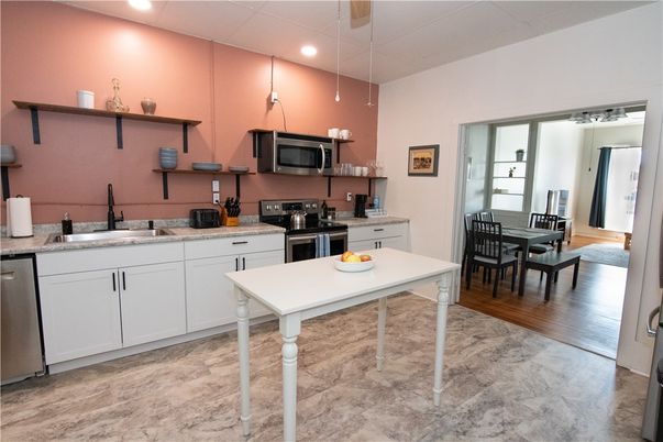 Dining room, Interior, Kitchen, Pendant Lights, Recessed Lighting, Stainless Steel Appliances, Wood Texture Flooring