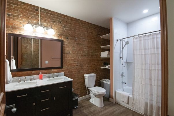 Bathroom, Dual Sink Vanities, Glass Shower, Interior, Recessed Lighting, Stone Walls, Wood Texture Flooring