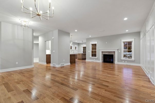 Empty room, Fireplace, Interior, Kitchen, Pendant Lights, Recessed Lighting, Wood Texture Flooring