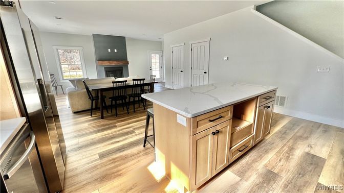 Dining room, Fireplace, Interior, Kitchen, Recessed Lighting, Wood Texture Flooring