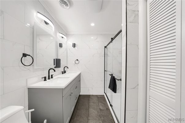 Bathroom, Dual Sink Vanities, Glass Shower, Interior, Marble Walls, Recessed Lighting