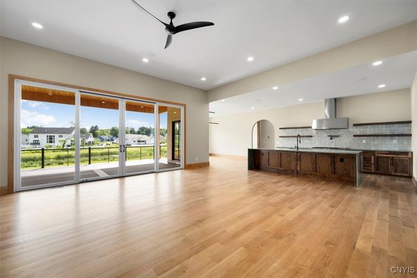 Empty room, Interior, Kitchen, Recessed Lighting, Stainless Steel Appliances, Wood Texture Flooring