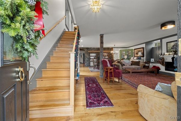 Chandelier, Dining room, Fireplace, Interior, Living room, Pendant Lights, Recessed Lighting, Wood Texture Flooring