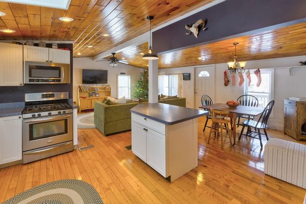 Chandelier, Dining room, Interior, Kitchen, Living room, Pendant Lights, Recessed Lighting, Stainless Steel Appliances, Wooden Ceilings, Wood Texture Flooring