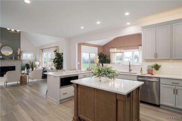 Chandelier, Fireplace, Interior, Kitchen, Living room, Pendant Lights, Recessed Lighting, Stainless Steel Appliances, Wood Texture Flooring