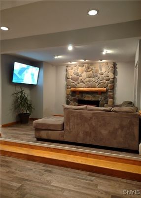 Fireplace, Interior, Living room, Recessed Lighting, Stone Walls, Wood Texture Flooring