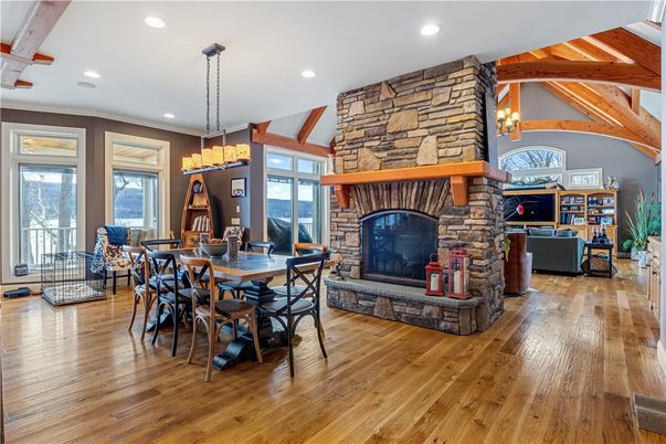 Chandelier, Dining room, Fireplace, Interior, Living room, Pendant Lights, Recessed Lighting, Stone Walls, Wooden Beams, Wood Texture Flooring