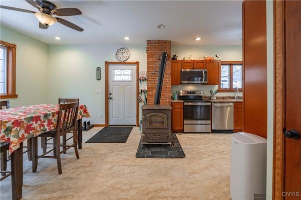Dining room, Fireplace, Interior, Kitchen, Recessed Lighting, Stainless Steel Appliances, Stone Walls