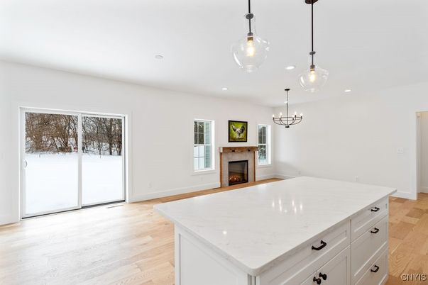 Empty room, Fireplace, Interior, Kitchen, Pendant Lights, Recessed Lighting, Wood Texture Flooring