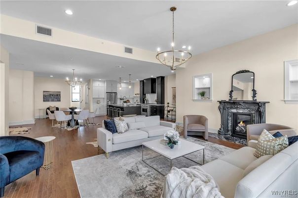 Chandelier, Dining room, Fireplace, Interior, Kitchen, Living room, Pendant Lights, Recessed Lighting, Stainless Steel Appliances, Wood Texture Flooring