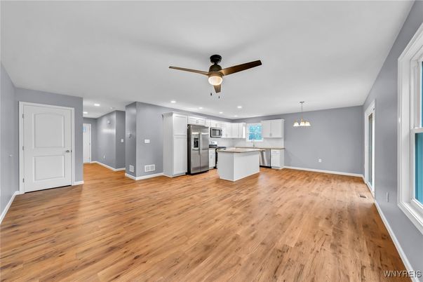 Empty room, Interior, Kitchen, Pendant Lights, Recessed Lighting, Stainless Steel Appliances, Wood Texture Flooring