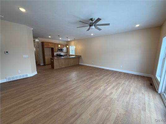 Empty room, Interior, Kitchen, Pendant Lights, Recessed Lighting, Stainless Steel Appliances, Wood Texture Flooring