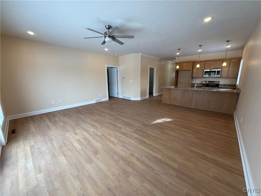 Empty room, Interior, Kitchen, Pendant Lights, Recessed Lighting, Stainless Steel Appliances, Wood Texture Flooring