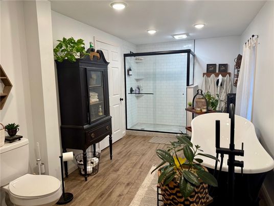 Bathroom, Free Standing Baths, Glass Shower, Interior, Recessed Lighting, Wood Texture Flooring
