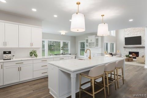 Fireplace, Interior, Kitchen, Living room, Pendant Lights, Recessed Lighting, Stainless Steel Appliances, Stone Walls, Wood Texture Flooring