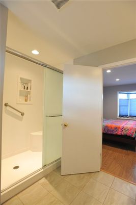 Bathroom, Bedroom, Glass Shower, Interior, Recessed Lighting, Wood Texture Flooring