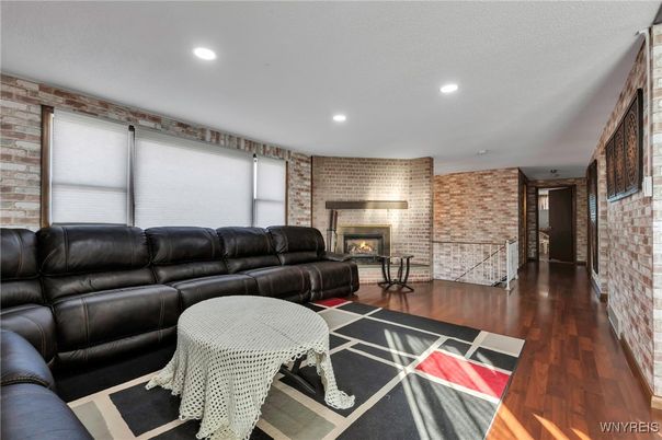 Fireplace, Interior, Living room, Recessed Lighting, Stone Walls, Wood Texture Flooring