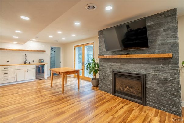 Dining room, Fireplace, Interior, Recessed Lighting, Stone Walls, Wood Texture Flooring