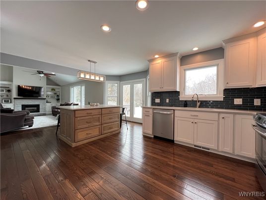 Dining room, Fireplace, Interior, Kitchen, Living room, Pendant Lights, Recessed Lighting, Stainless Steel Appliances, Wood Texture Flooring