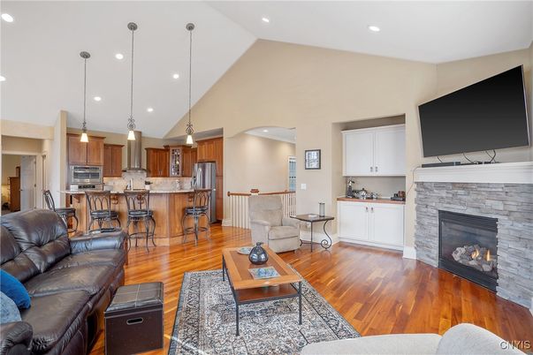 Fireplace, Interior, Kitchen, Living room, Pendant Lights, Recessed Lighting, Stainless Steel Appliances, Stone Walls, Wood Texture Flooring