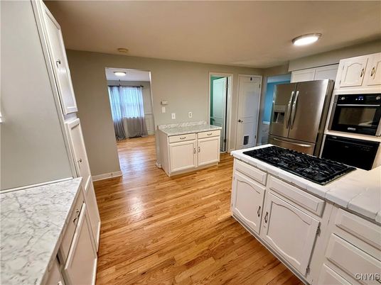 Interior, Kitchen, Recessed Lighting, Tile Countertops, Wood Texture Flooring