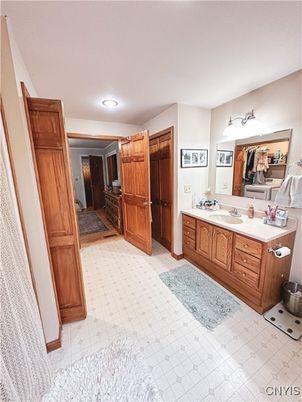 Bathroom, Dual Sink Vanities, Glass Shower, Interior, Recessed Lighting, Wood Texture Flooring