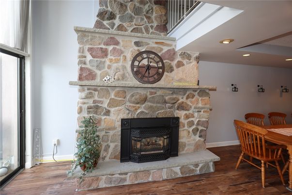 Dining room, Fireplace, Interior, Recessed Lighting, Stone Walls, Wood Texture Flooring