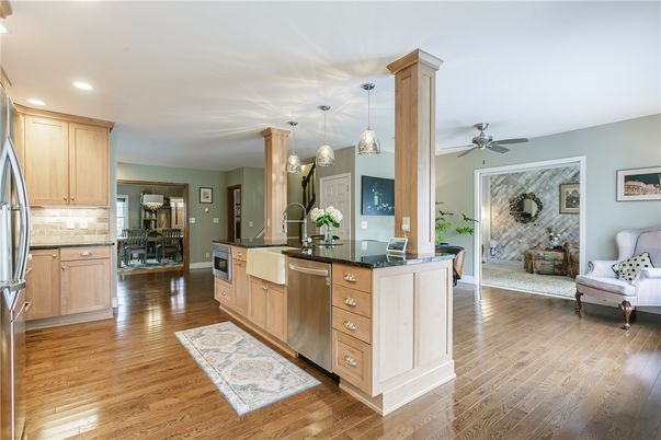 Dining room, Fireplace, Interior, Kitchen, Pendant Lights, Recessed Lighting, Stainless Steel Appliances, Stone Walls, Wood Texture Flooring