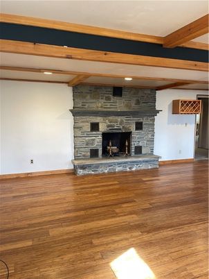 Empty room, Fireplace, Interior, Recessed Lighting, Stone Walls, Wooden Beams, Wood Texture Flooring