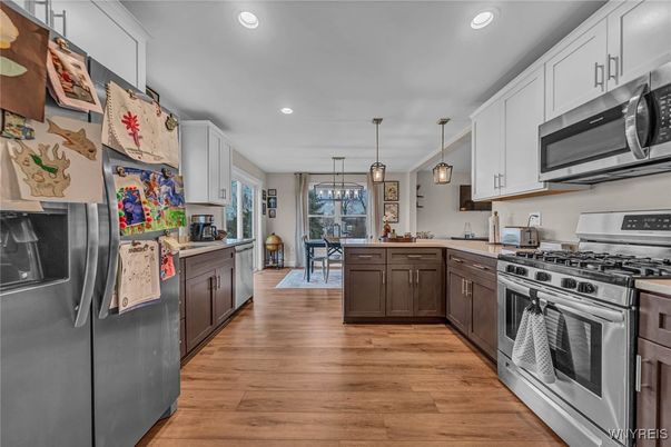 Dining room, Interior, Kitchen, Pendant Lights, Recessed Lighting, Stainless Steel Appliances, Wood Texture Flooring