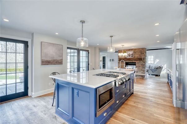 Fireplace, Interior, Kitchen, Living room, Pendant Lights, Recessed Lighting, Stainless Steel Appliances, Stone Walls, Wood Texture Flooring