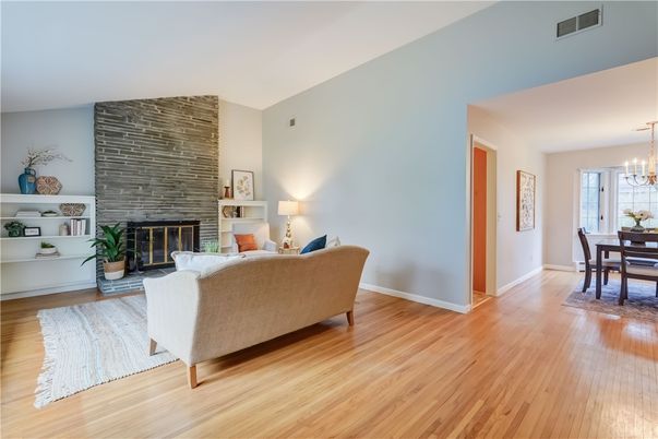 Chandelier, Dining room, Fireplace, Interior, Living room, Stone Walls, Wood Texture Flooring