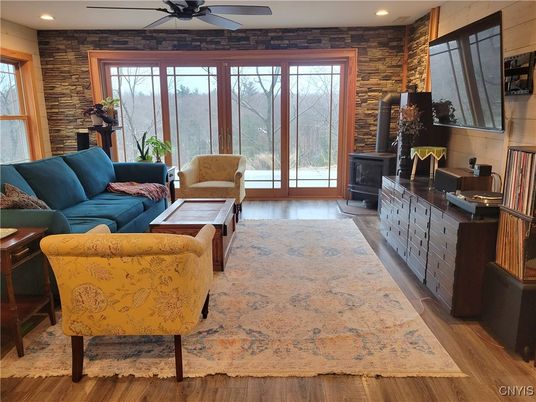 Fireplace, Interior, Living room, Recessed Lighting, Stone Walls, Wood Texture Flooring
