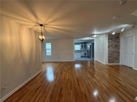 Empty room, Interior, Kitchen, Pendant Lights, Stainless Steel Appliances, Stone Walls, Wood Texture Flooring