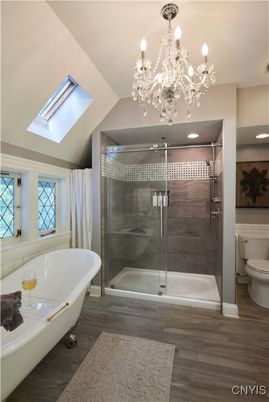 Bathroom, Chandelier, Free Standing Baths, Glass Shower, Interior, Recessed Lighting, Wood Texture Flooring