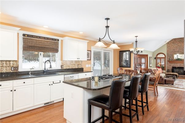Chandelier, Dining room, Fireplace, Interior, Kitchen, Living room, Pendant Lights, Recessed Lighting, Stone Walls, Wood Texture Flooring